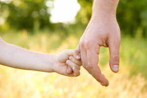 parent holding childs hand